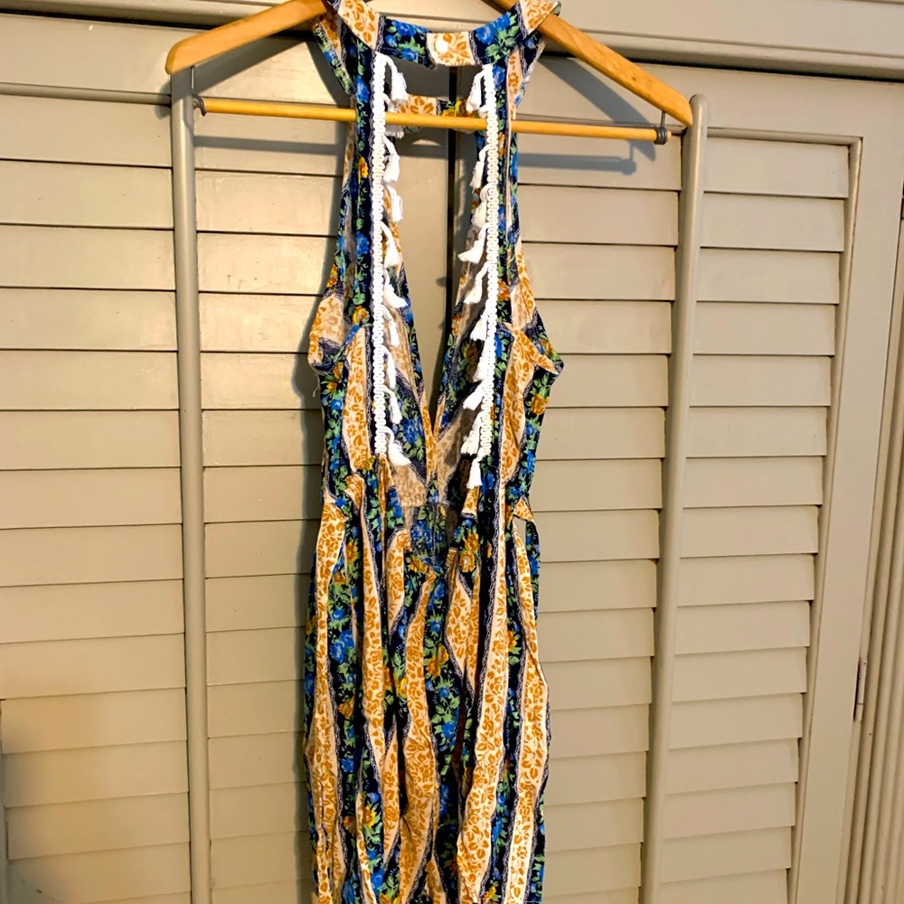 Fun shorts romper with tassel details. Size L.